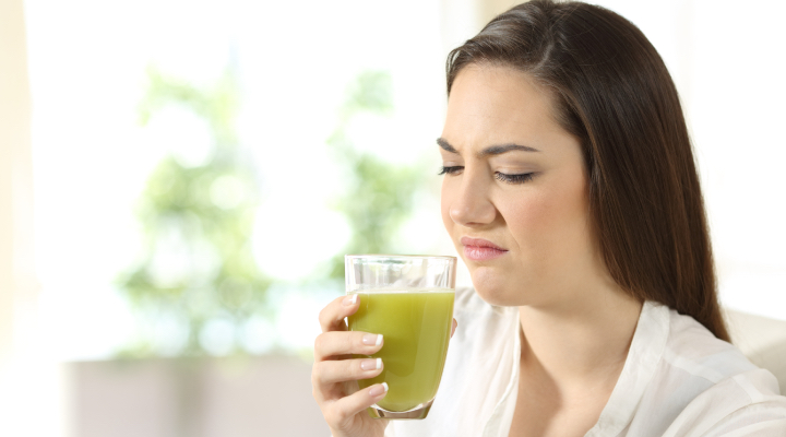 Woman experiencing bad breath after brushing her teeth