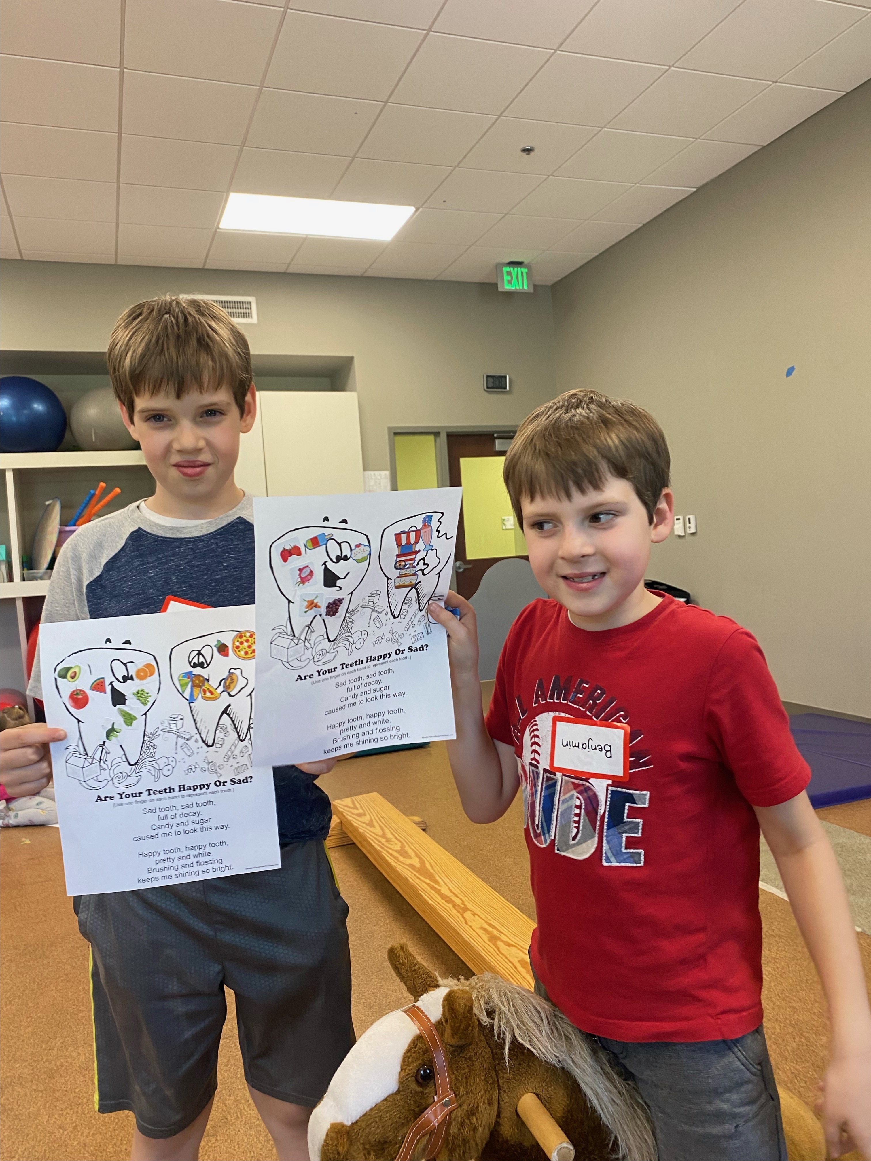 2 boys with coloring sheets