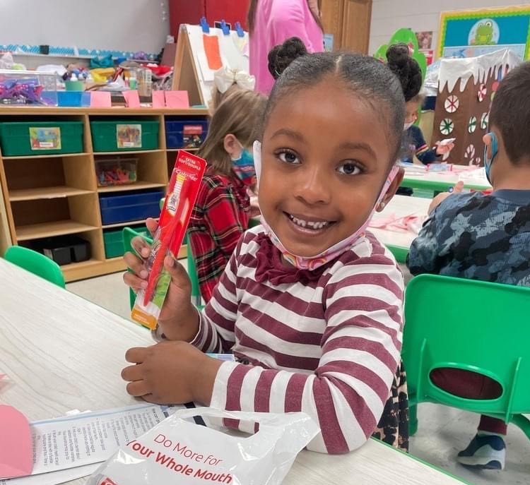 Student with Toothbrush Kit