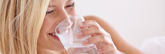 Woman drinking water with fluoride