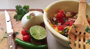 Bowl of fresh homemade salsa with tomatoes, lime, jalapeno and cilantro